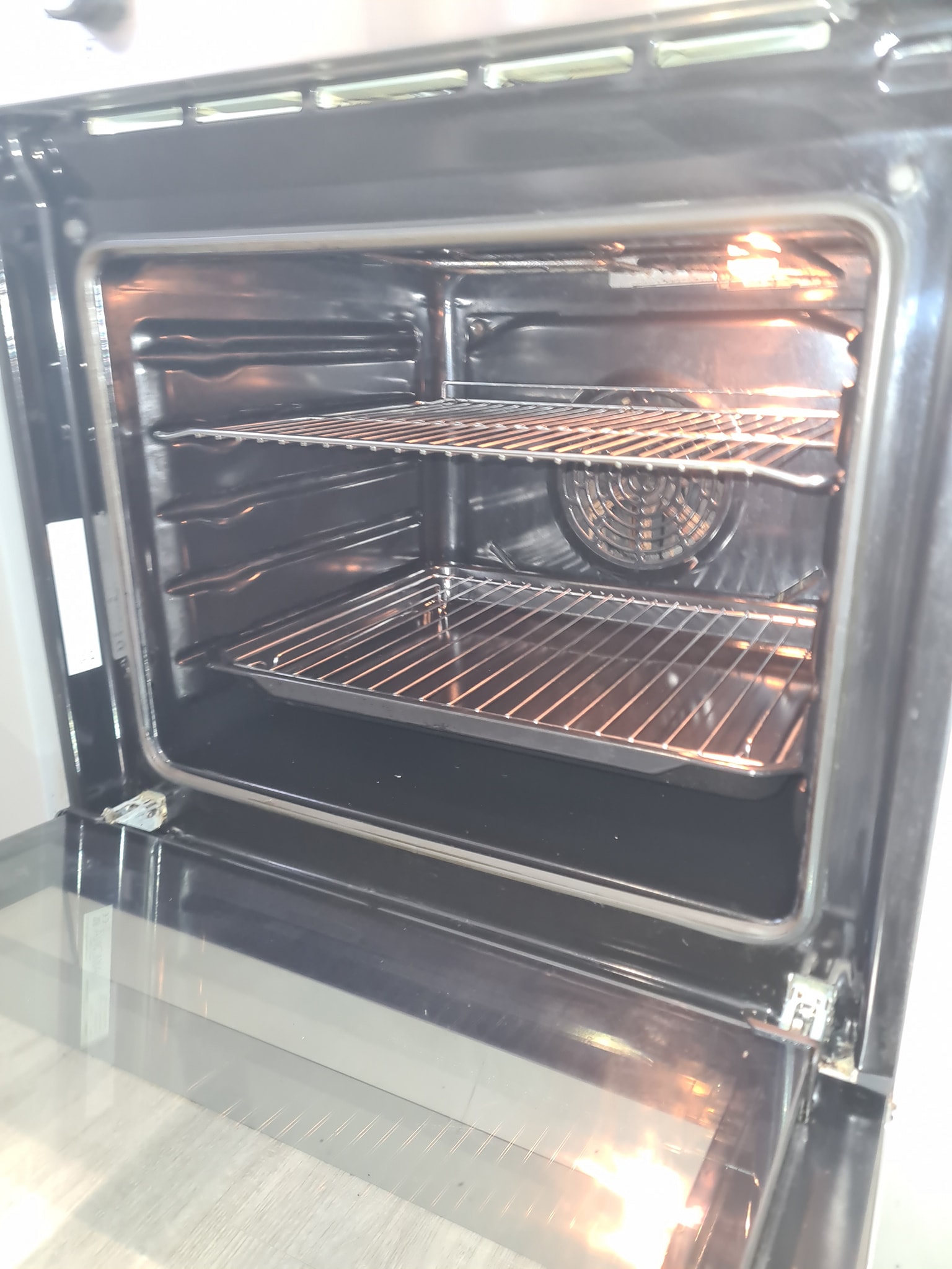 Clean oven interior with pristine racks after professional cleaning